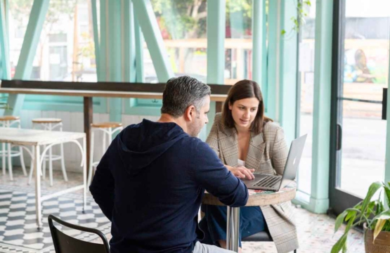 A man and woman, discussing the importance of sales enablement automation in the current market landscape.